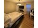 Modern bedroom with wooden floors, TV, and desk at 3160 Del Dotto Walk, Henderson, NV 89044