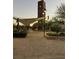 A courtyard features a tower, shade structure, shrubbery, and hardscape at 3160 Del Dotto Walk, Henderson, NV 89044