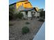 Landscaped home exterior showcasing a well-maintained front yard with desert landscaping and mature bushes at 3160 Del Dotto Walk, Henderson, NV 89044