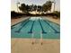 The pool has clear water with blue stripes, ladders, and community seating nearby at 3160 Del Dotto Walk, Henderson, NV 89044
