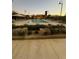 Community pool featuring lounge seating, shade umbrellas, shrubbery, and an attractive building at 3160 Del Dotto Walk, Henderson, NV 89044