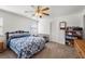 Cozy bedroom featuring a ceiling fan, carpeted floors, and a window for natural light at 320 Cimmarron Pl, Pahrump, NV 89048