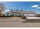 Charming single-story home featuring a three-car garage, manicured landscaping and tile roof at 320 Cimmarron Pl, Pahrump, NV 89048