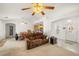 Spacious living room open to the dining area and kitchen featuring tile and carpet flooring at 320 Cimmarron Pl, Pahrump, NV 89048