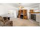Cozy living room featuring a fireplace, built-in shelving, and a ceiling fan at 320 Cimmarron Pl, Pahrump, NV 89048