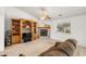 Inviting living room with a fireplace, ceiling fan, and custom built-in shelving at 320 Cimmarron Pl, Pahrump, NV 89048