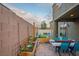 Serene backyard offers a dining table and chairs, plus plenty of room for flowers and decor at 340 Largo Vista Ct, North Las Vegas, NV 89084