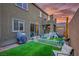 Spacious backyard featuring a small turf area with room to play, surrounded by a white picket fence at 340 Largo Vista Ct, North Las Vegas, NV 89084