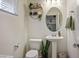 Stylish half bathroom featuring decorative wallpaper, vanity sink, and modern fixtures at 340 Largo Vista Ct, North Las Vegas, NV 89084