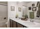 Bright bathroom boasts double sinks, framed art, and a shower-tub combo for a clean, classic design at 340 Largo Vista Ct, North Las Vegas, NV 89084