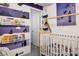 Adorable Bedroom featuring a whimsical Peter Pan theme and a modern white crib with wood frame at 340 Largo Vista Ct, North Las Vegas, NV 89084