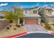 Beautiful two-story home featuring a brick driveway, desert landscaping, and a modern architectural design at 340 Largo Vista Ct, North Las Vegas, NV 89084