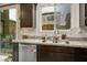 View of kitchen sink and granite counter top near window with backyard view and patio access at 340 Largo Vista Ct, North Las Vegas, NV 89084