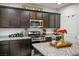 Well-equipped kitchen featuring stainless steel appliances, dark cabinets, and granite countertops at 340 Largo Vista Ct, North Las Vegas, NV 89084
