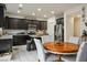 Eat-in kitchen featuring dark wood cabinets, stainless steel appliances, and a dining table with chairs at 340 Largo Vista Ct, North Las Vegas, NV 89084