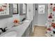 Bathroom boasts double sinks with granite counters and shower with festive red truck wallpaper at 3675 W Maule Ave, Las Vegas, NV 89118