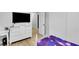 Bedroom with a white dresser, desk, TV and wood-look tile at 3675 W Maule Ave, Las Vegas, NV 89118