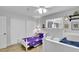 Bright bedroom featuring a ceiling fan, window, closet, wood-look tile and twin beds at 3675 W Maule Ave, Las Vegas, NV 89118