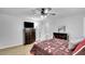 Bedroom with ceiling fan, wood-look tile, TV, dresser and decorative quilt on the bed at 3675 W Maule Ave, Las Vegas, NV 89118