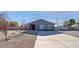 Charming home with a long concrete driveway, desert landscaping and grey brick perimeter wall at 3675 W Maule Ave, Las Vegas, NV 89118