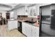 Bright kitchen features white cabinets, black appliances, and a double basin sink at 3675 W Maule Ave, Las Vegas, NV 89118
