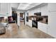 Spacious kitchen with white cabinets, black appliances, and long countertops at 3675 W Maule Ave, Las Vegas, NV 89118