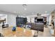Open-concept living room with dining area, wood floors, and custom built-in cabinets at 3675 W Maule Ave, Las Vegas, NV 89118