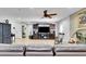 Bright living room featuring a stone fireplace, ceiling fan, and comfortable seating at 3675 W Maule Ave, Las Vegas, NV 89118