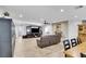 Open concept living room featuring a ceiling fan, fireplace, dark furniture and an attached dining area at 3675 W Maule Ave, Las Vegas, NV 89118