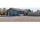Grey home featuring a covered patio, a concrete block outdoor kitchen, and rock landscaping at 3675 W Maule Ave, Las Vegas, NV 89118