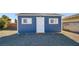 A bright blue storage shed stands out with crisp white trim and windows at 3675 W Maule Ave, Las Vegas, NV 89118