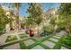 Manicured backyard with stone pavers and garden areas at 3863 Glasgow Green Dr, Las Vegas, NV 89141