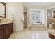 Luxurious bathroom featuring a soaking tub, walk-in shower, and dual vanities at 3863 Glasgow Green Dr, Las Vegas, NV 89141