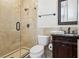 Charming bathroom featuring an elegant vanity, large mirror, and walk-in shower with neutral tile at 3863 Glasgow Green Dr, Las Vegas, NV 89141