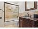 Elegant bathroom featuring a shower over tub, stylish vanity, and neutral tile surround at 3863 Glasgow Green Dr, Las Vegas, NV 89141