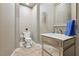 Stylish powder room featuring a mirrored vanity, elegant lighting, and decorative wallpaper at 3863 Glasgow Green Dr, Las Vegas, NV 89141