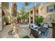 Inviting courtyard features seating area, tall palm trees, and architectural columns at 3863 Glasgow Green Dr, Las Vegas, NV 89141