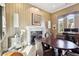 Dining room featuring a marble fireplace, custom drapes, and plenty of sunlight at 3863 Glasgow Green Dr, Las Vegas, NV 89141