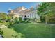 An elegantly stucco home with a beautifully maintained front lawn and manicured shrubs at 3863 Glasgow Green Dr, Las Vegas, NV 89141