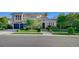 Elegant stucco home with dark blue garage doors, tile roof, and a professionally landscaped front yard at 3863 Glasgow Green Dr, Las Vegas, NV 89141