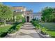 Stucco home featuring manicured landscaping, tile roof, and a stone walkway leading to the front door at 3863 Glasgow Green Dr, Las Vegas, NV 89141