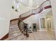 Grand foyer with curved staircase, elegant chandelier, and stylish decor at 3863 Glasgow Green Dr, Las Vegas, NV 89141