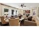 Inviting living room with large windows, comfortable seating, and a convenient wet bar at 3863 Glasgow Green Dr, Las Vegas, NV 89141