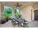 Covered patio featuring a dining table with seating and views of the landscaped backyard at 3863 Glasgow Green Dr, Las Vegas, NV 89141
