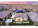 Aerial view of a house with a backyard featuring outdoor kitchen, dining area, and solar panels on the roof at 3929 Reyes Ave, Las Vegas, NV 89141