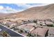 An aerial view shows a desert neighborhood featuring well-built homes, set against a rugged mountain backdrop at 3929 Reyes Ave, Las Vegas, NV 89141