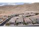 Expansive desert homes nestled against a backdrop of rocky hills in a neighborhood with well-maintained streets at 3929 Reyes Ave, Las Vegas, NV 89141