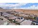 Stunning aerial view showcases a vibrant neighborhood nestled against picturesque desert hillsides under a partly cloudy sky at 3929 Reyes Ave, Las Vegas, NV 89141