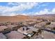A picturesque desert neighborhood with homes featuring tile roofs set against mountains, showcasing solar panels on roofs at 3929 Reyes Ave, Las Vegas, NV 89141