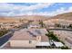 Expansive aerial view featuring a property with solar panels, a stylish outdoor living area, and mountain views at 3929 Reyes Ave, Las Vegas, NV 89141